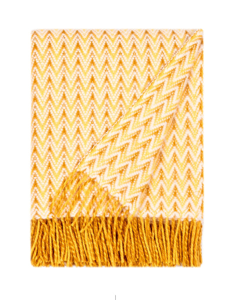Yellow wool throw featuring wave-like ripple texture and fringed edges, bright and cozy lambswool design. Alrun Nordic Design