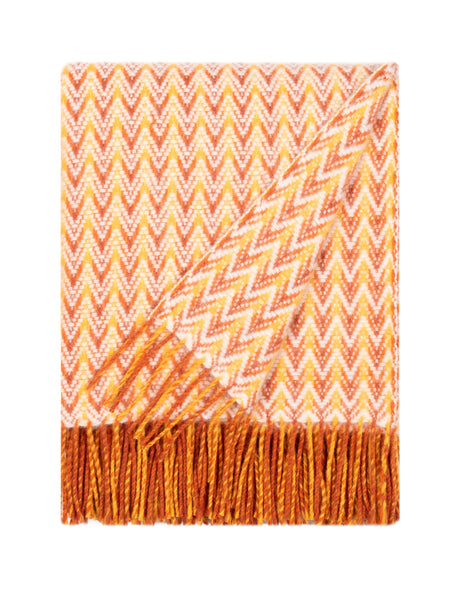 Orange wool throw with ripple-inspired texture and fringed edges,  made from soft lambswool. Alrun Nordic Design