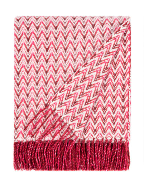 Red wave-pattern wool blanket with soft lambswool texture and fringed edges, luxurious for sofas or beds